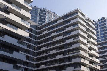 Facades of large residential buildings against the blue sky.