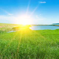 Obraz premium Estuary lake, reeds and sun.