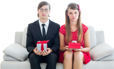 Unsmiling geeky couple with gift