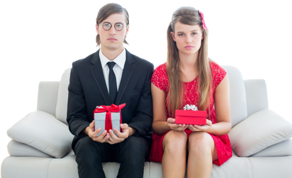 Unsmiling geeky couple with gift