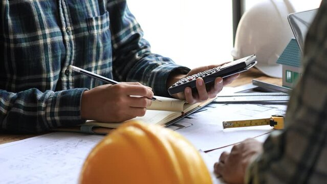 Architects and engineers are working together to edit the draft house plan that was designed after it was presented to the client and partially revised the design. Interior design and decoration ideas