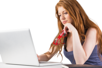 Pretty redhead working on laptop