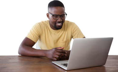 Smiling man looking into laptop at table