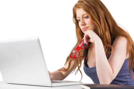 Pretty redhead working on laptop