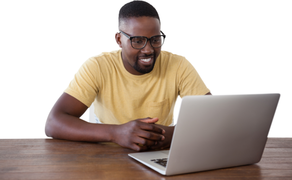 Smiling man looking into laptop at table