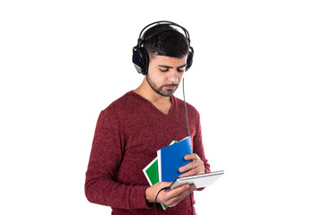 Fototapeta premium Work and study. Young attractive student listens to lectures in headphones.