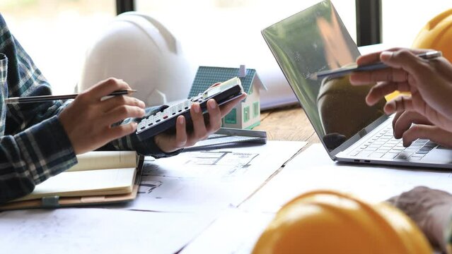 Architects and engineers are working together to edit the draft house plan that was designed after it was presented to the client and partially revised the design. Interior design and decoration ideas