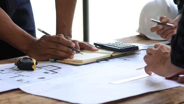 Architects and engineers are working together to edit the draft house plan that was designed after it was presented to the client and partially revised the design. Interior design and decoration ideas