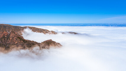 Mountains jut through the cloud cover at Pico do Arieiro on Madeira in Portugal