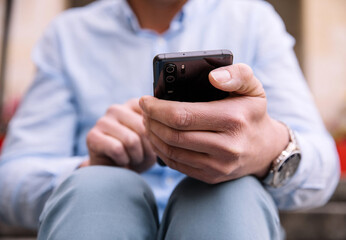 A business person with a smartphone in the city. Business vision, communications, online shopping.