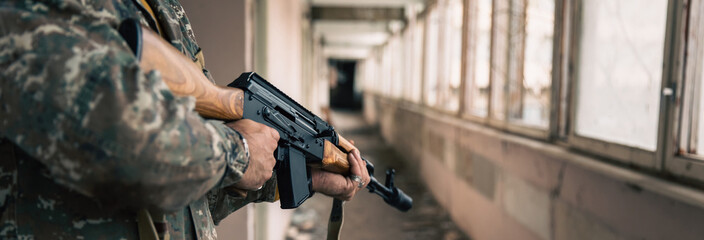 Fototapeta premium a man with a gun in destroyed building