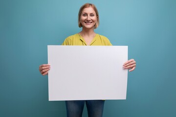 smiling blonde mature woman holding note board with mocap