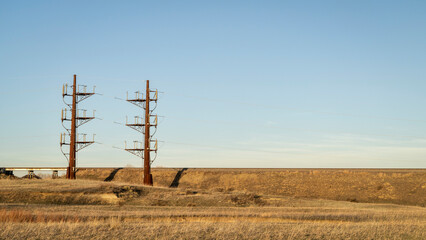 industrial landscape of northern Colorado with a power line and railroad, early spring