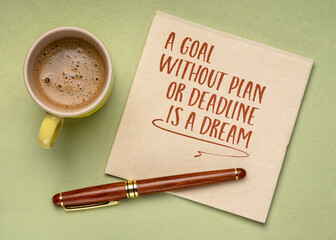 A goal without plan or deadline is a dream. Inspirational note or reminder on a napkin with coffee.
