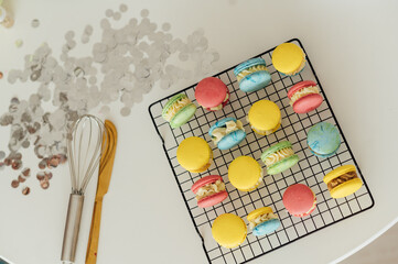 traditional french colorful macarons in a rows on a metal mesh