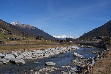 Kampl, Austria - March 16, 2023 - modification of the Ruetz riverbed in an alpine valley Stubaital at the end of the winter season