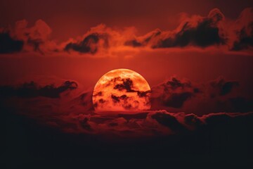 red sun with clouds behind on the dark sky, a red sun with clouds in the background