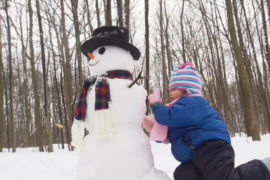 Girl Making Snowman