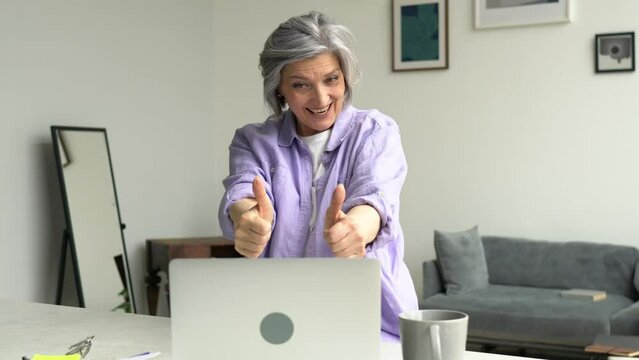 Caucasian female friends in different age category enjoying live communication for discussing web design of startup project, cheerful women with laptop computer and smartphone device laughing in home
