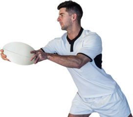 Rugby player leaning over while holding the ball