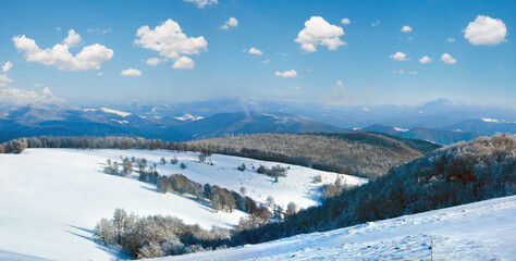 October misty mountain panorama with first winter snow. Carpathians, Ukraine.