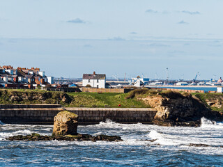 View over Collywell Bay with Charlie's Garden rock formation to Seaton Sluice and Blyth, Northumberland, UK