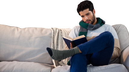 Man sitting on sofa while reading book