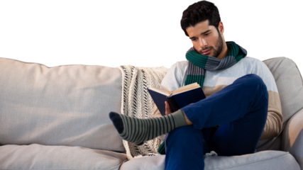 Man sitting on sofa while reading book