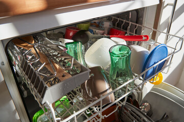 Side view of dishes and utensils in a dishwasher