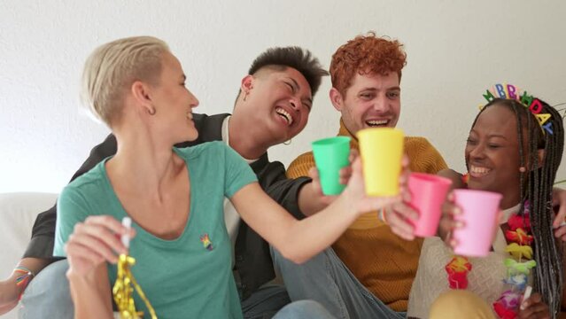 Friends toasting and laughing while celebrate at home