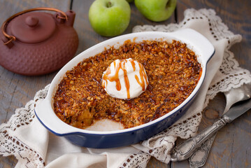Homemade Apple Crisp or Apple Crumble with toasted crunchy streusel topped with vanilla ice cream...