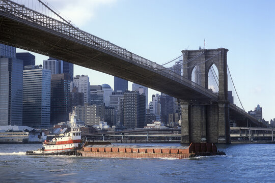 Barge Passing Under Brooklyn Bridge, New York City, New York, USA