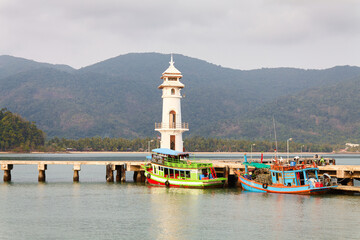 Fototapeta na wymiar An evening landscape with a marina and a lighthouse in Thailand, on Koh Chang Island, in 2010.