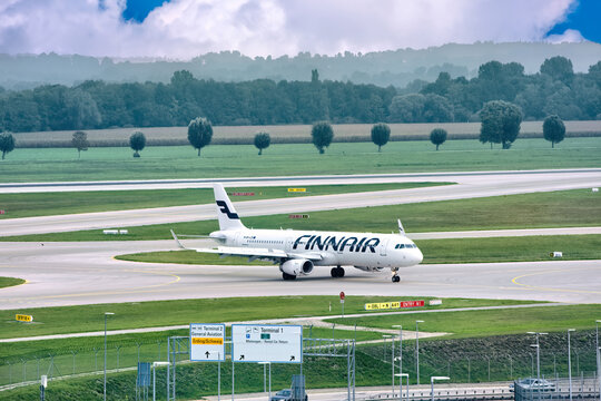 A big FinnAir jet is getting ready for boarding at the airport in summer: Munich, Germany - September 15, 2018