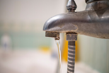 Bathroom faucet old dirty in plaque and rust, dirty water concept