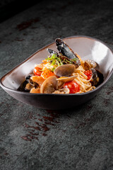 Italian spaghetti pasta marinara with Clams, Prawns, Mussels, tomato, Seafood Cocktail in plate