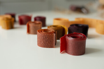 Fruit marshmallows rolled up lies on the table