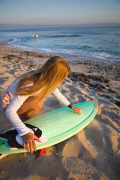 Surfer Waxing Board on the Beach, Punta Burros, Nayarit, Mexico