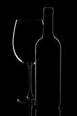 Bordo wine glass and bottle silhouette still life on black background