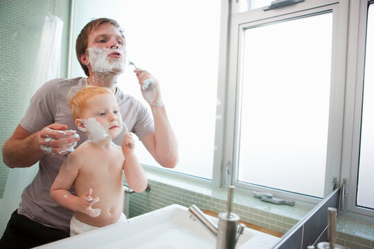 Father and Son Shaving in Bathroom, Portland, Oregon, USA