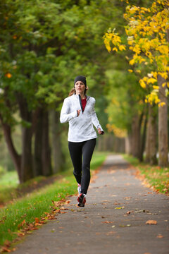 Woman Jogging through Park, Seattle, Washington, USA