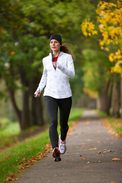Woman Jogging through Park, Seattle, Washington, USA