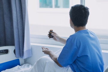 patient sat on the bed and looked out the window in the hospital alone and had stress, boredom, loneliness, anxiety. / Health care and medical
