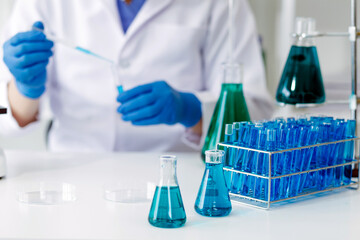 biochemical research scientist team working with microscope for coronavirus vaccine development in pharmaceutical research labolatory, selective focus