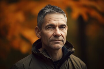 Portrait of a mature man in an autumn park. Toned.