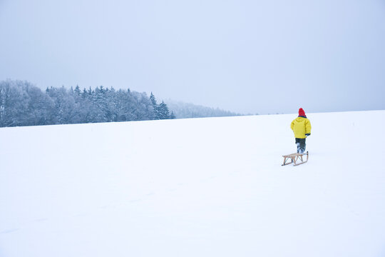 Boy Pulling Toboggan