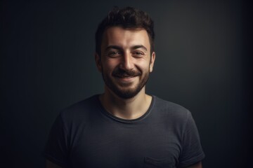 Portrait of a handsome young man with a beard on a dark background