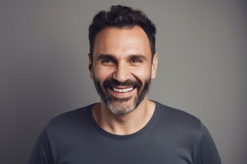 Obraz premium Portrait of handsome bearded man in black t-shirt, isolated on grey background