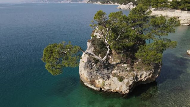 Brela, Croatia. Natural landmark rock island with sturdy pine trees. Punta Rata.
