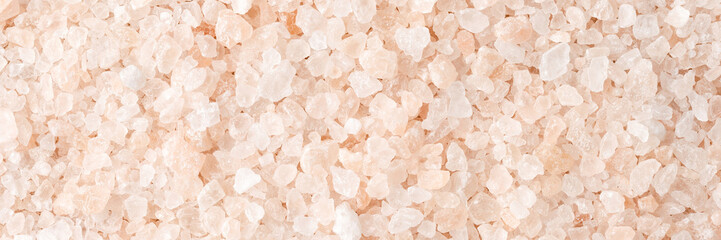 Pink himalayan salt texture. Background with copyspace. Close up. Top view